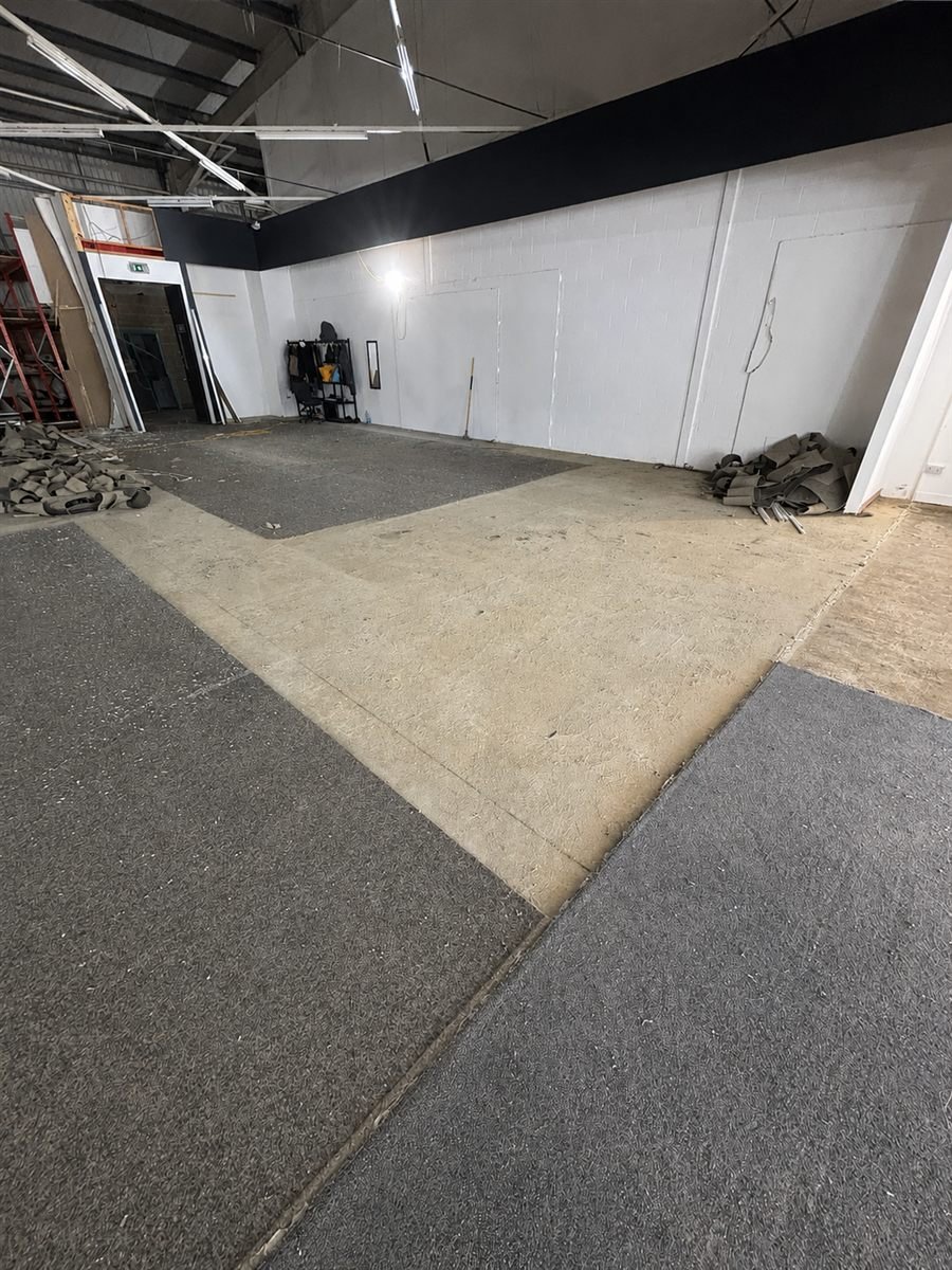 Interior soft strip in progress — cleared floor and stripped-back unit interior
